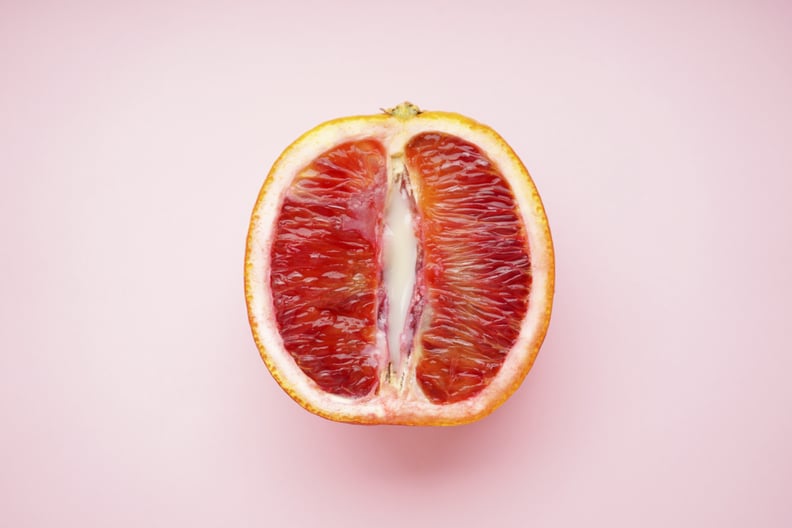 Blood orange on a pink background.