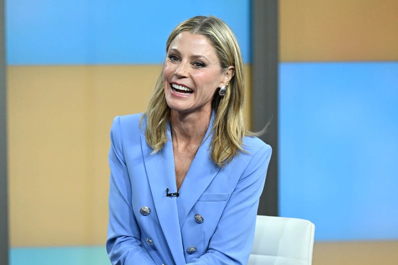 Julie Bowen smiling in blue suit during an interview.